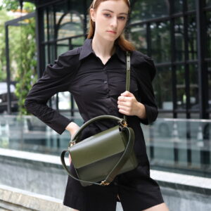 Bozo23 premium leather bags worn by woman on shoulder and grasped in hand.